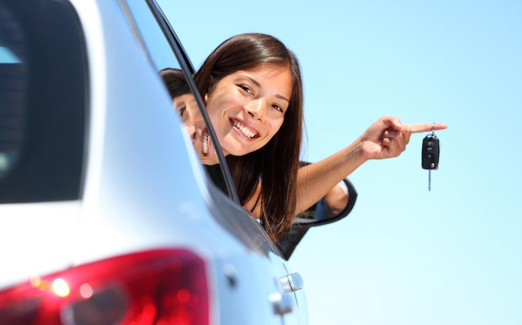 Driver woman showing new car keys